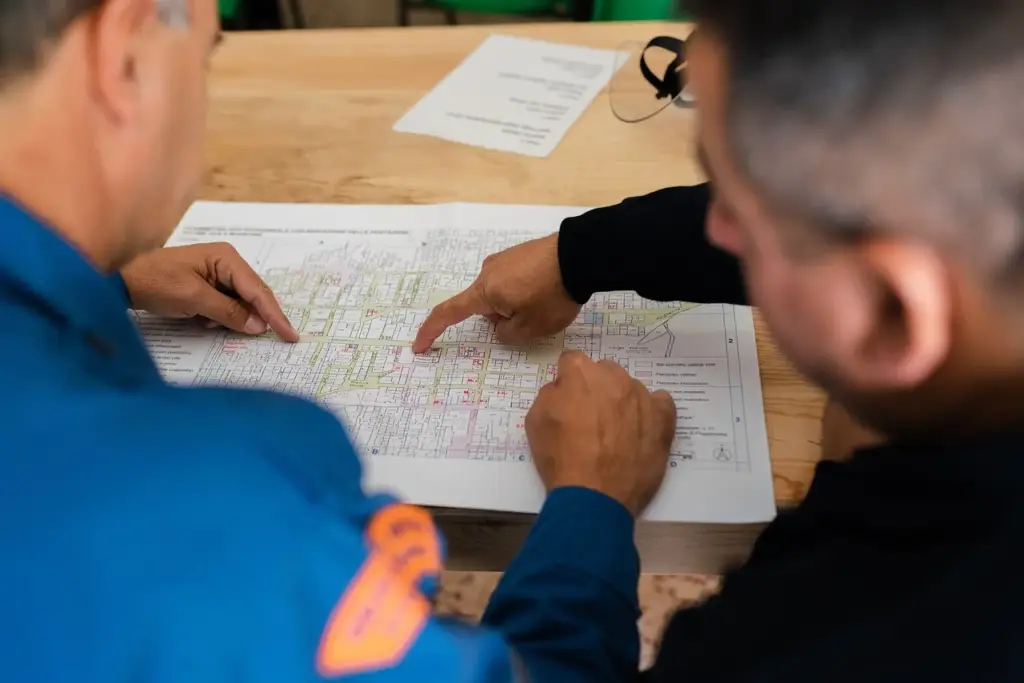 Two software engineers discussing a system architecture diagram