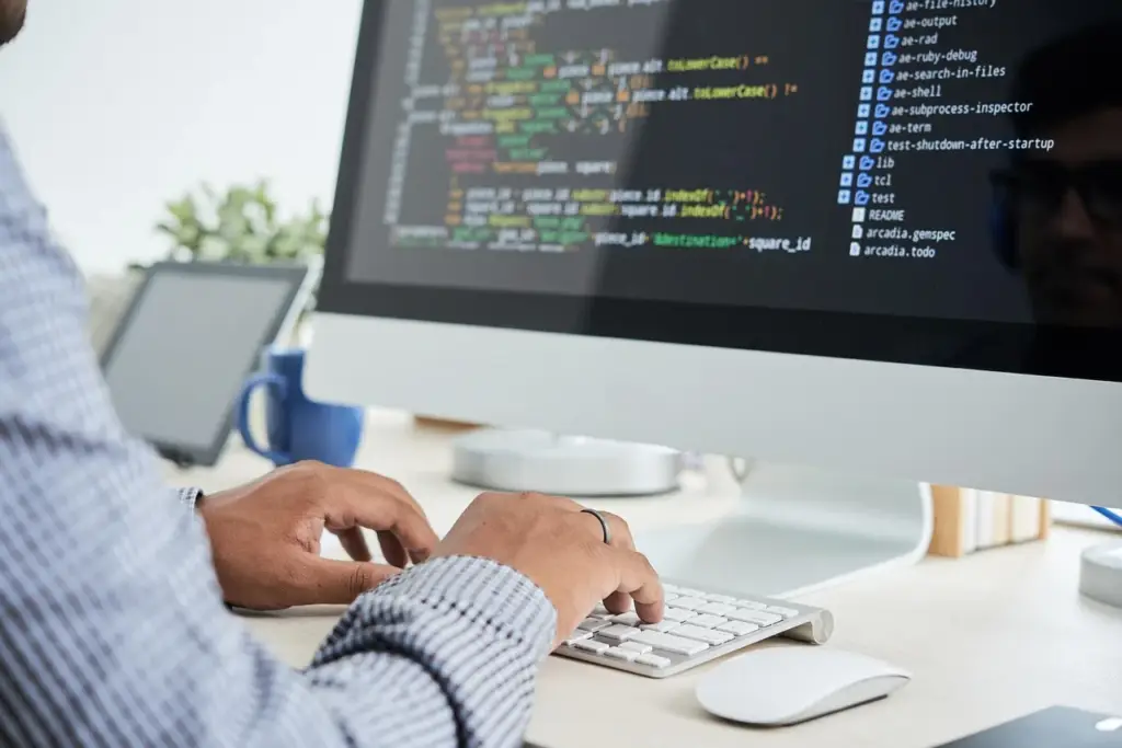 programmer typing on a keyboard with code on screen for input validation