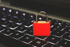 cybersecurity concept with a padlock on computer code representing API security