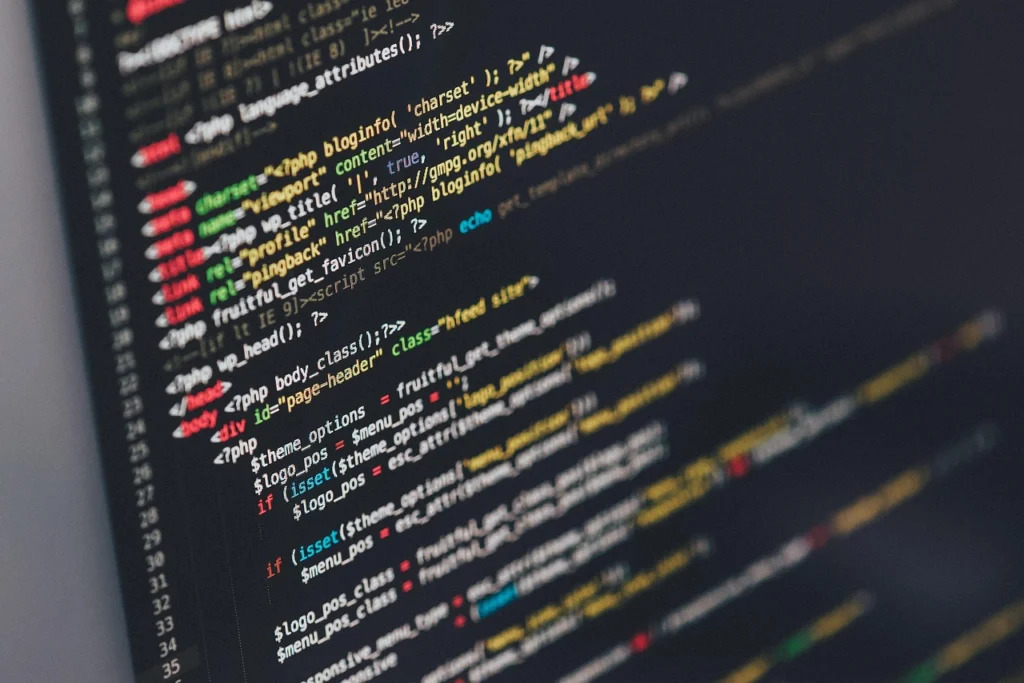 Code on screen with magnifying glass searching for Node.js memory leak