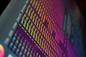 Developer working on laptop with terminal showing code deployment